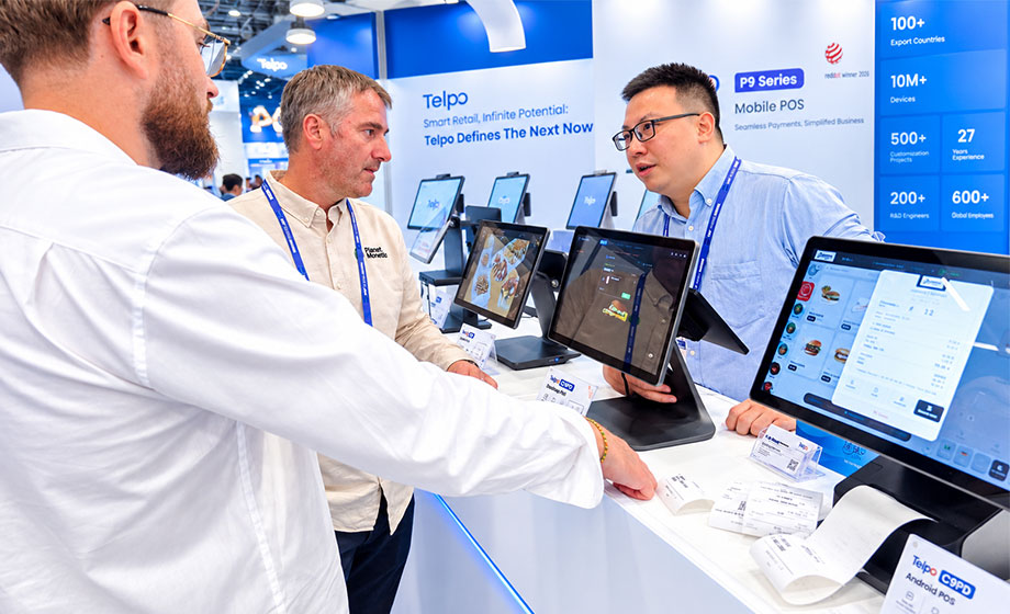 Telpo business representative discussing smart retail solutions with visitors at NRF Europe 2026